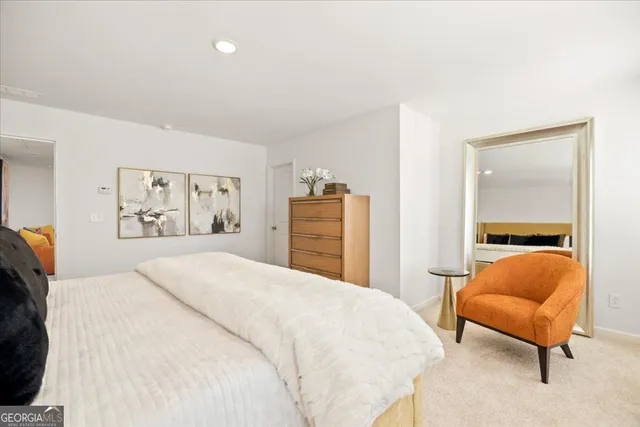 a bedroom with a bed and a lamp