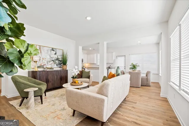 a living room with furniture and a potted plant