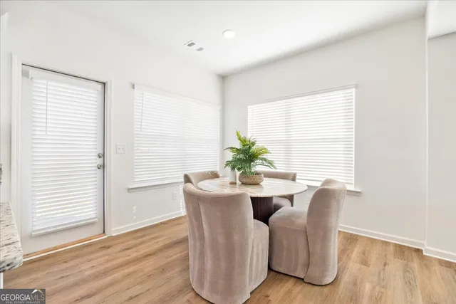 a view of a dining room with furniture and wooden floor