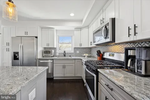 a kitchen with a sink stove and refrigerator