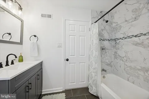 a view of staircase with wooden floor and white walls