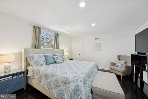 a bathroom with a bathtub sink vanity and mirror