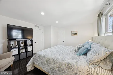 a bedroom with a large bed and a night stand