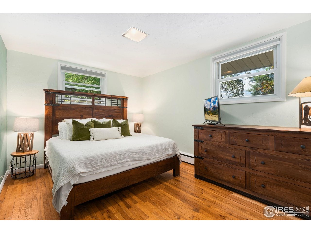 7908 Stuart Place Westminster, CO 80030 - Photo 15 of 30 a bedroom with a bed and a painting on the wall