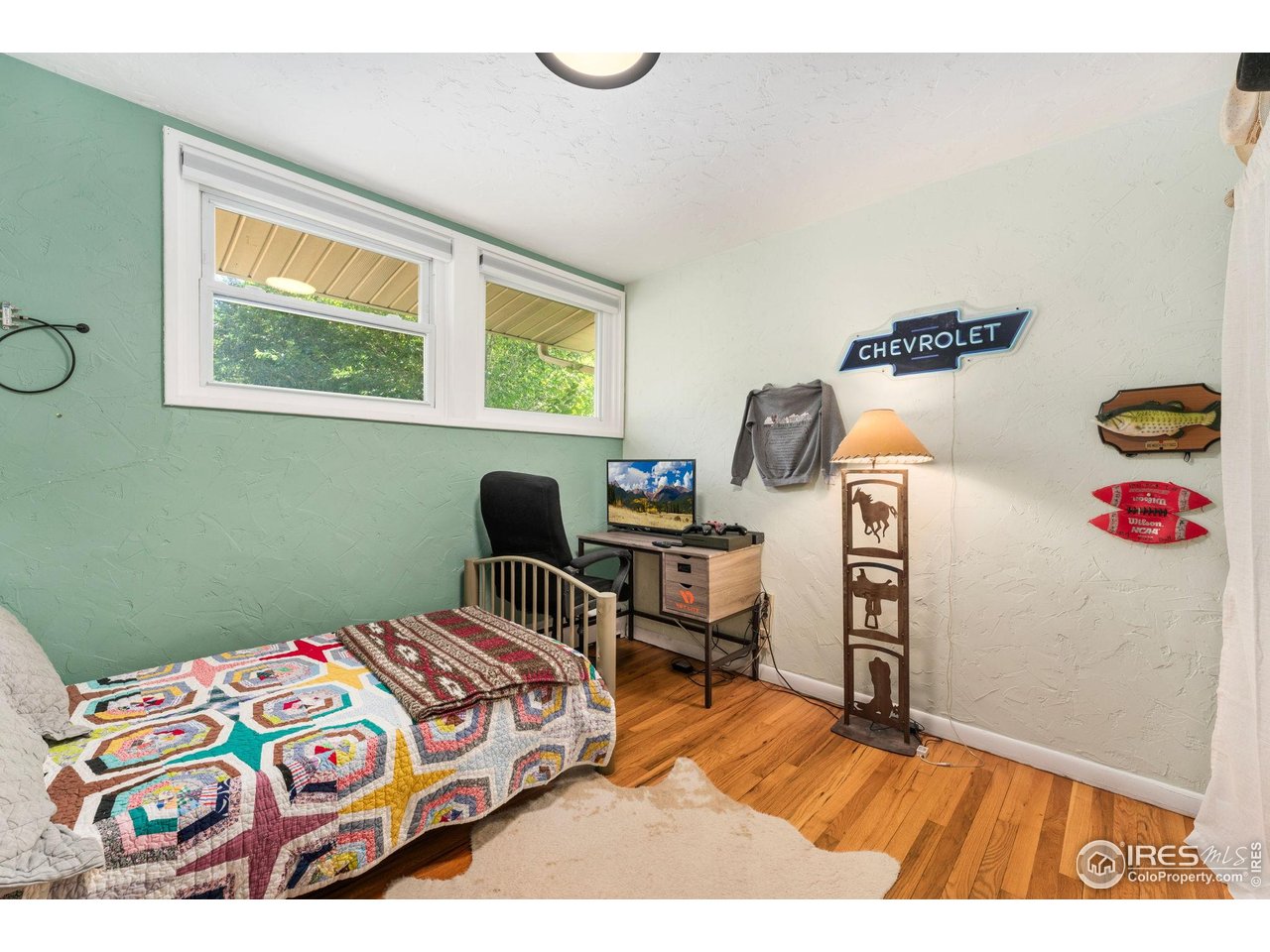 7908 Stuart Place Westminster, CO 80030 - Photo 18 of 30 a bedroom with a bed and wooden floor