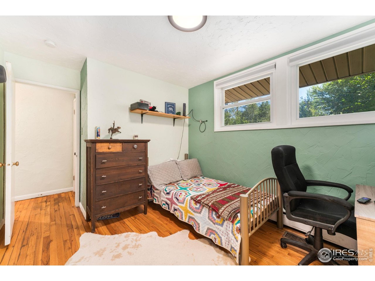 7908 Stuart Place Westminster, CO 80030 - Photo 19 of 30 a bedroom with a bed and furniture