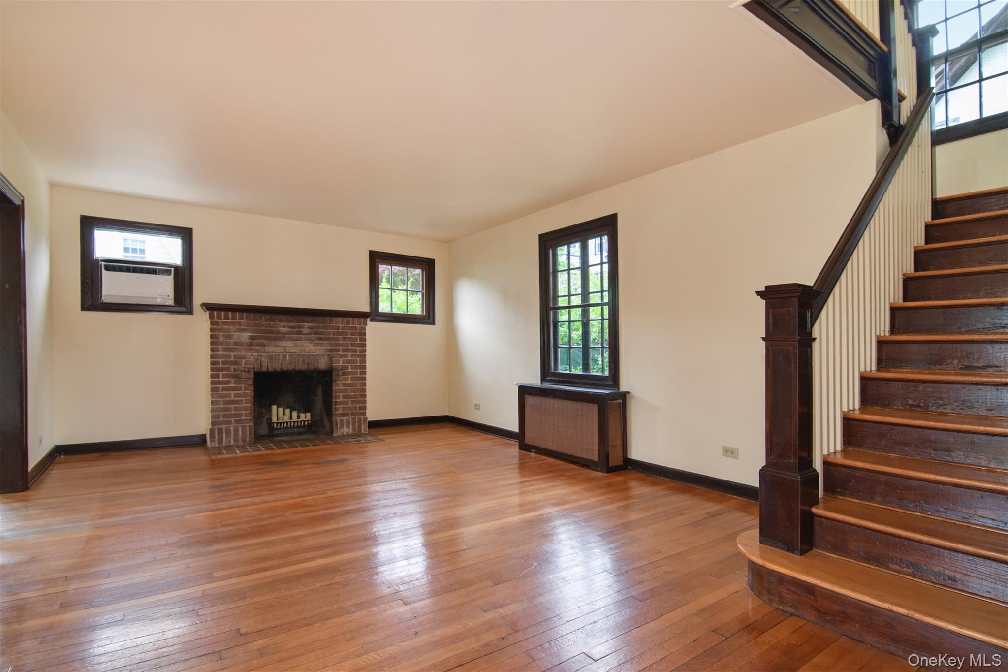 370 Scarsdale Road Tuckahoe, NY 10707 - Photo 4 of 25 Spacious interior featuring wood-finish flooring and a brick fireplace