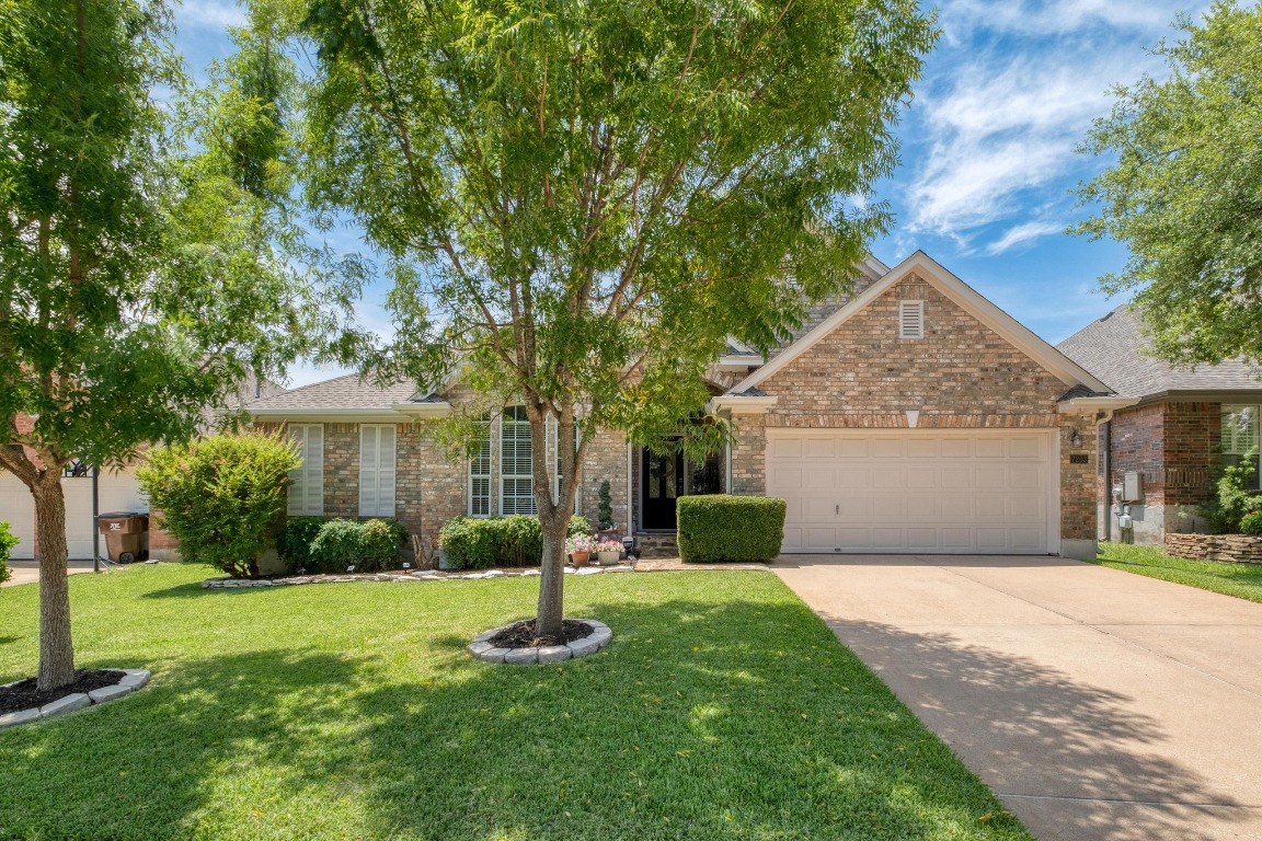 a front view of house with yard and green space