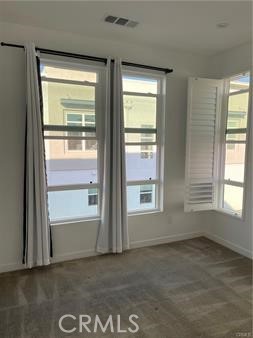 2320 Synergy Irvine, CA 92614 - Photo 14 of 17 an empty room with wooden floor and windows