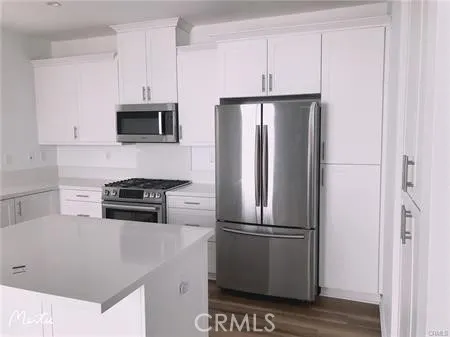 a kitchen with stainless steel appliances a refrigerator stove and microwave