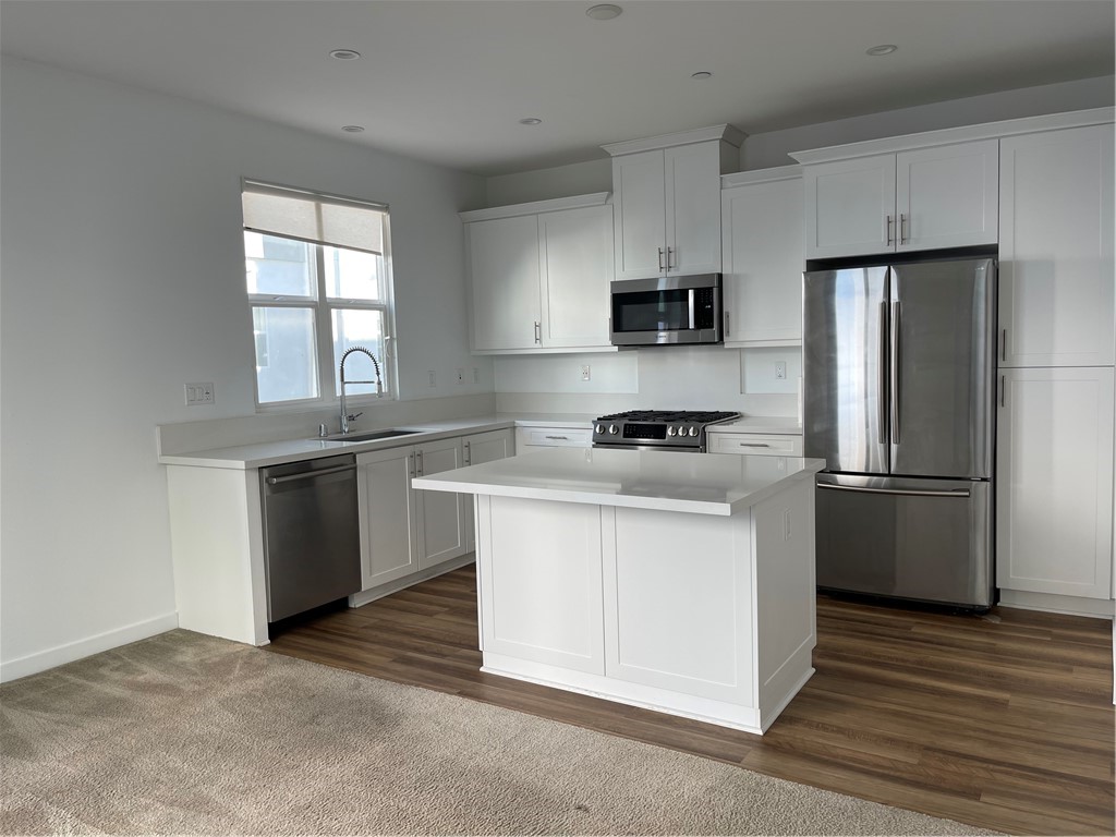 2320 Synergy Irvine, CA 92614 - Photo 10 of 17 a kitchen with stainless steel appliances a refrigerator stove and microwave