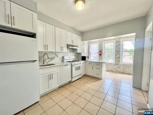 a kitchen with a cabinets and appliances