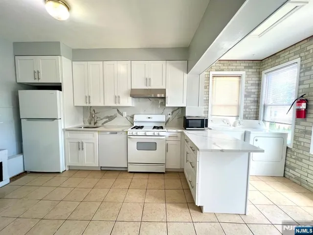 a kitchen with a stove top oven sink and cabinets