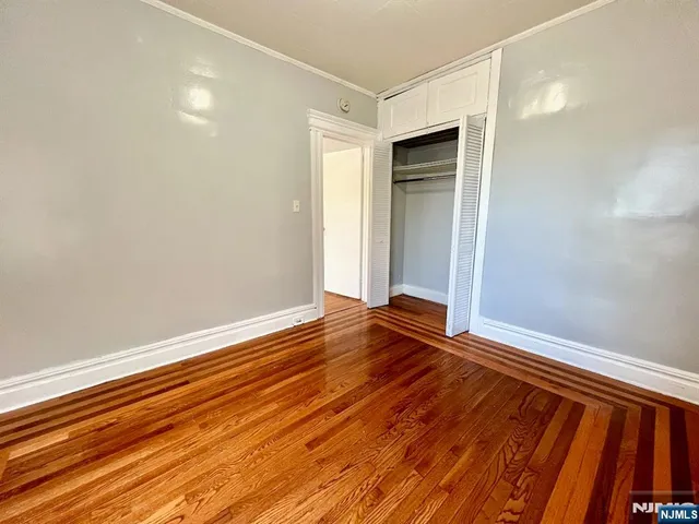 a view of room with window and wooden floor