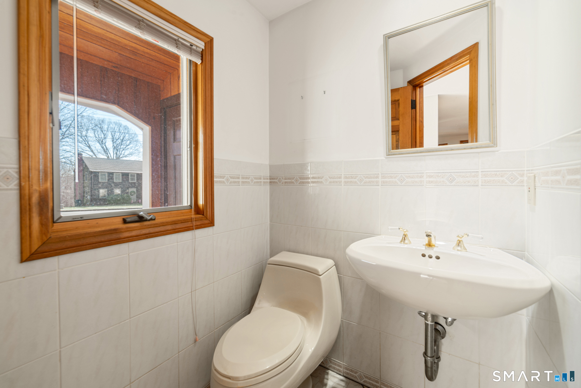 91 Gleeson Road Middletown, CT 06457 - Photo 11 of 39 a bathroom with a toilet a sink and a mirror