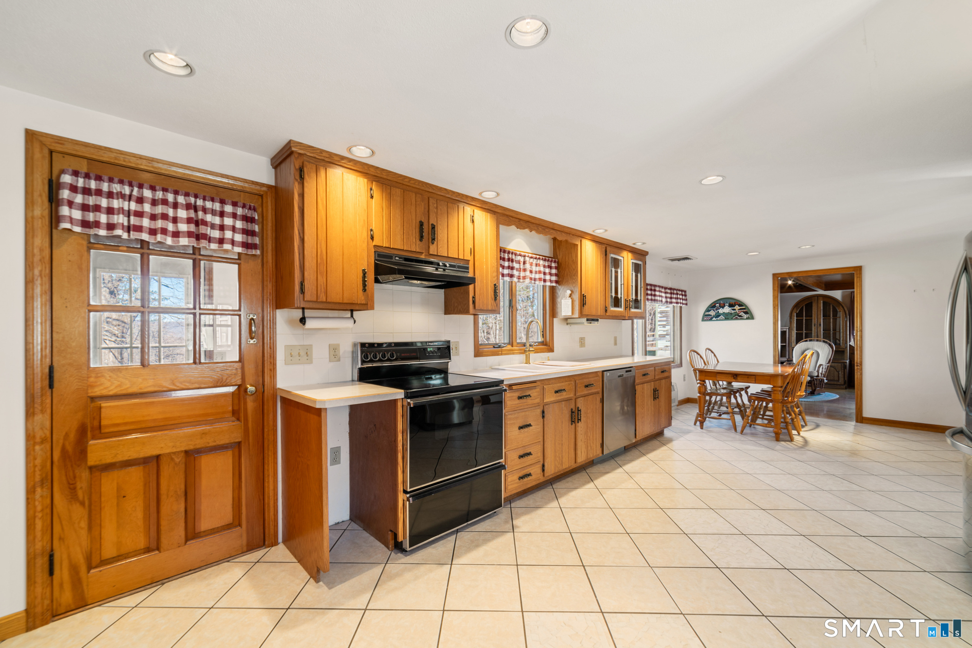 91 Gleeson Road Middletown, CT 06457 - Photo 3 of 39 a kitchen with stainless steel appliances granite countertop a stove top oven a sink a dining table and chairs