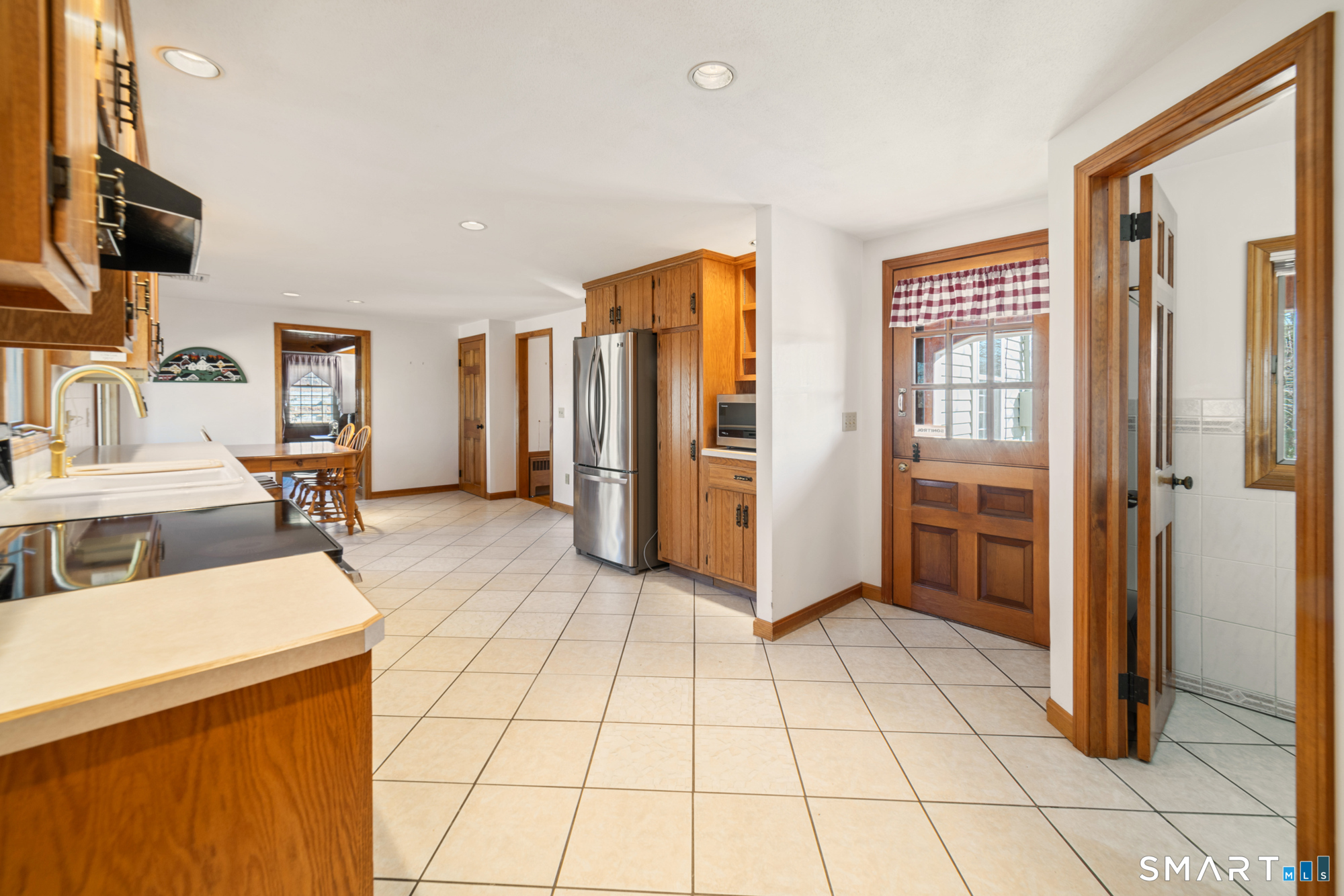 91 Gleeson Road Middletown, CT 06457 - Photo 4 of 39 a view of a kitchen with fridge and workspace