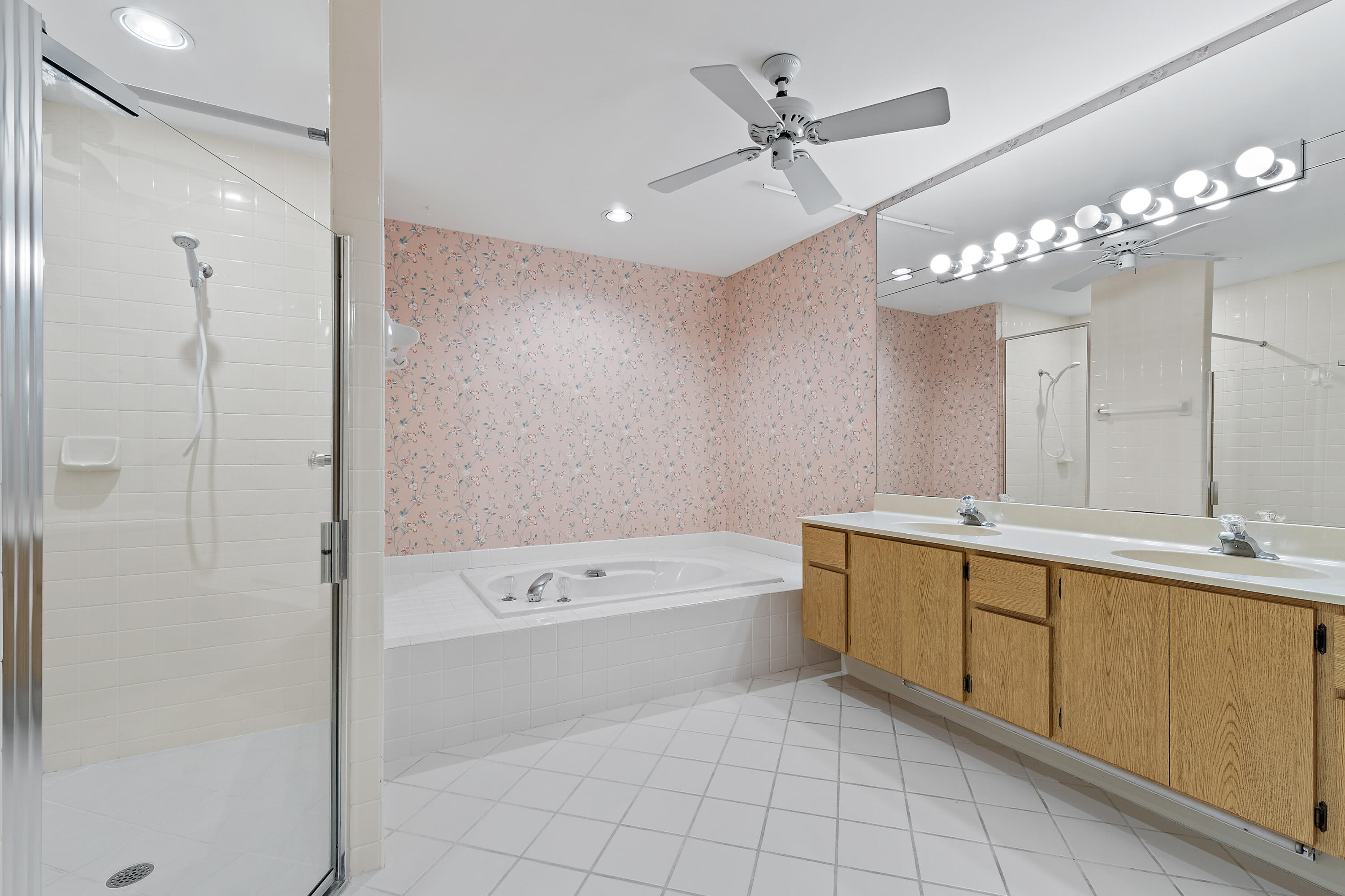 348 River Edge Road Jupiter, FL 33477 - Photo 12 of 30 a bathroom with a tub sink and mirror