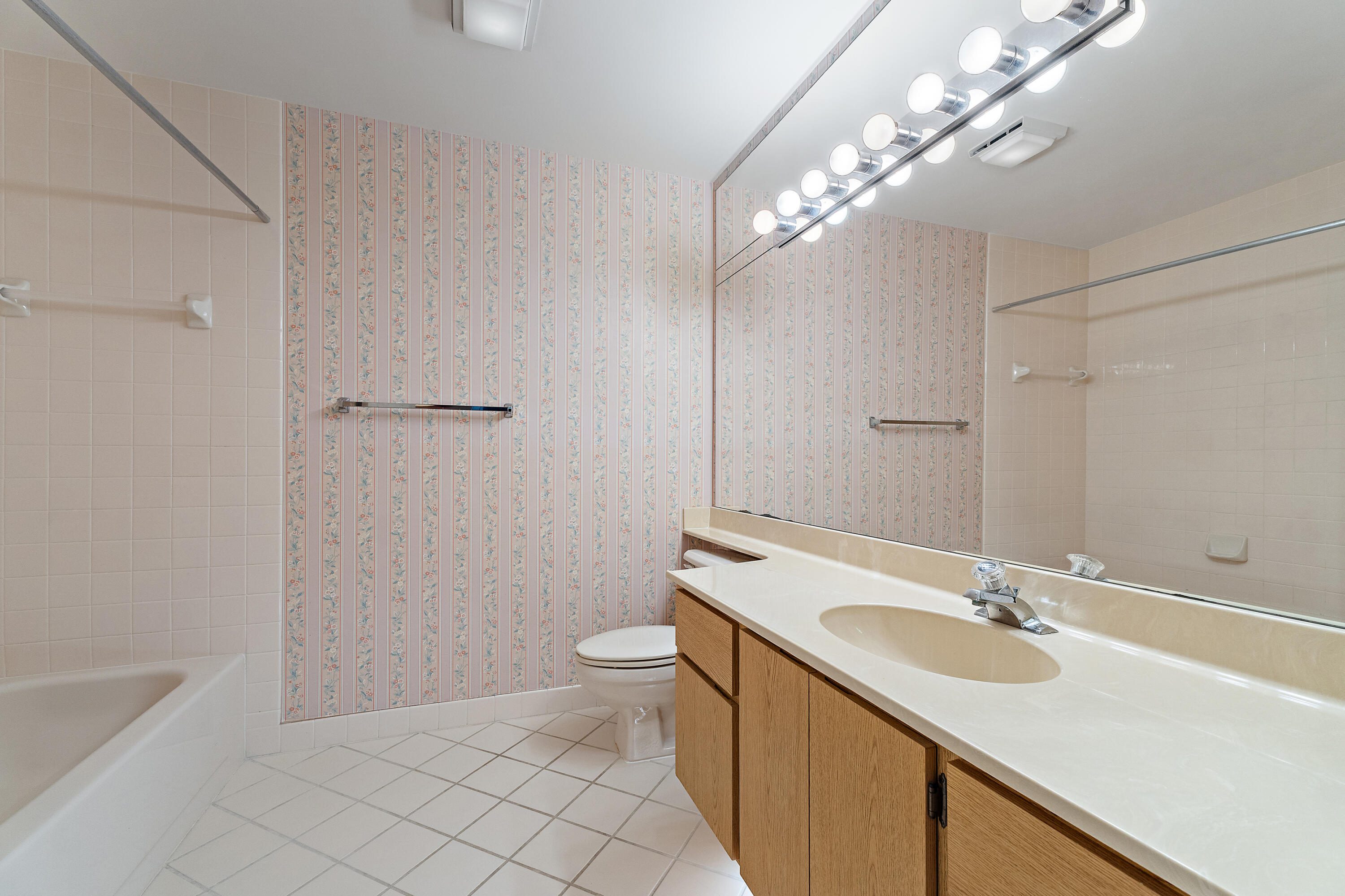 348 River Edge Road Jupiter, FL 33477 - Photo 15 of 30 a bathroom with a sink a toilet and a large mirror