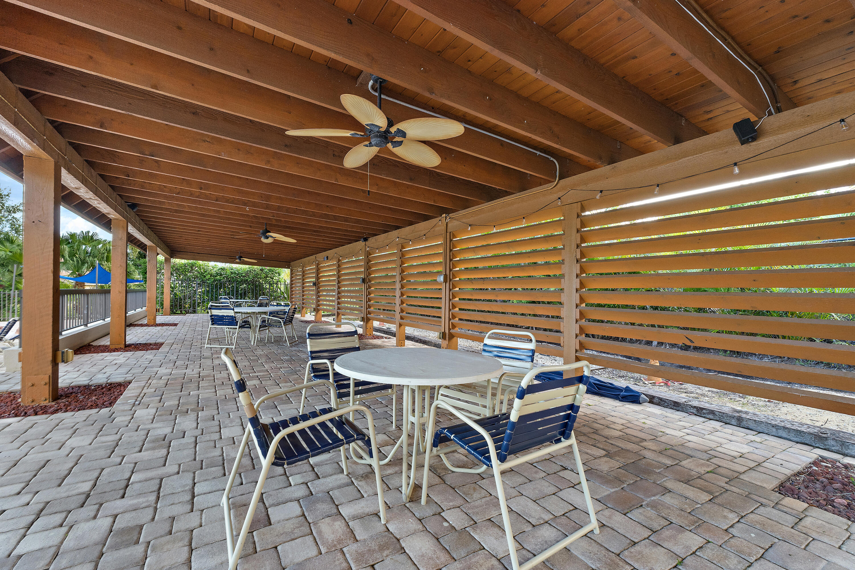 348 River Edge Road Jupiter, FL 33477 - Photo 27 of 30 a patio with table and chairs