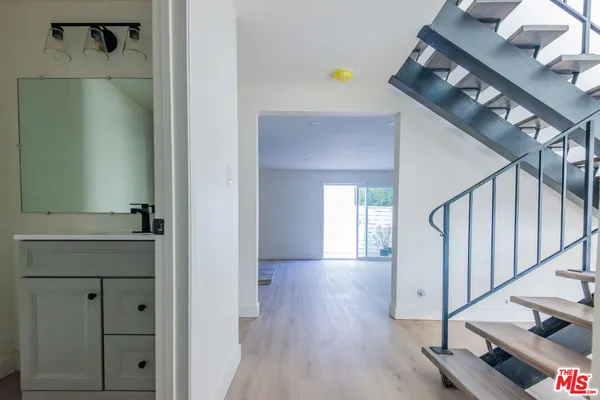 a view of a hallway with entryway wooden floor and front door