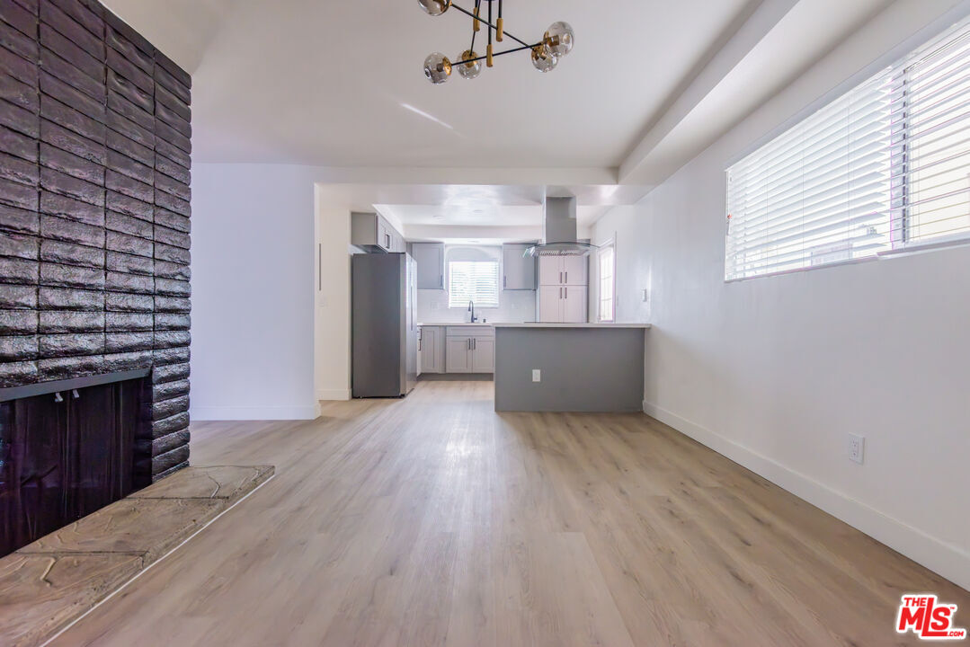 1303 Beryl Street Redondo Beach, CA 90277 - Photo 21 of 31 a big room with wooden floor fireplace and windows