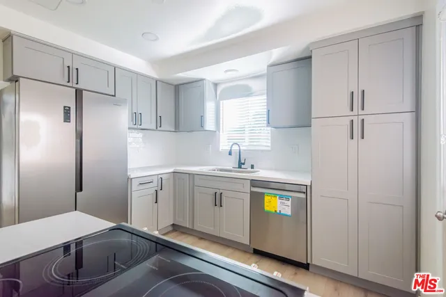 a kitchen with refrigerator and window