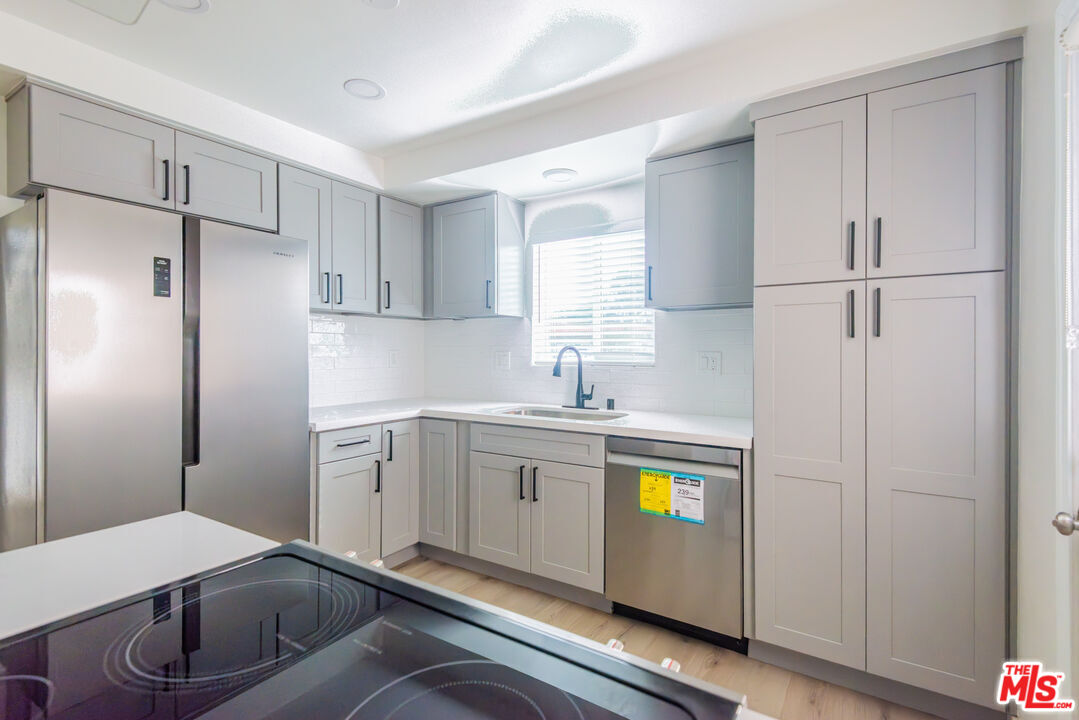1303 Beryl Street Redondo Beach, CA 90277 - Photo 22 of 31 a kitchen with refrigerator and window