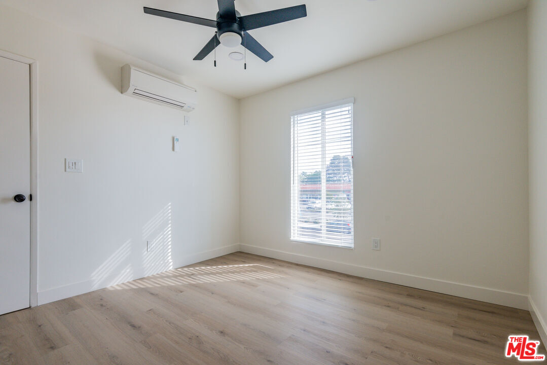 1303 Beryl Street Redondo Beach, CA 90277 - Photo 26 of 31 an empty room with wooden floor ceiling fan and windows