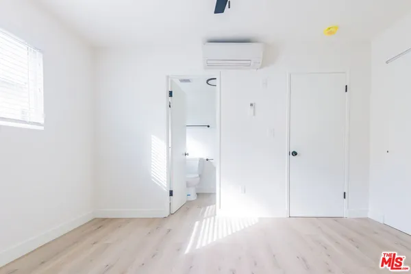 a view of a room with wooden floor