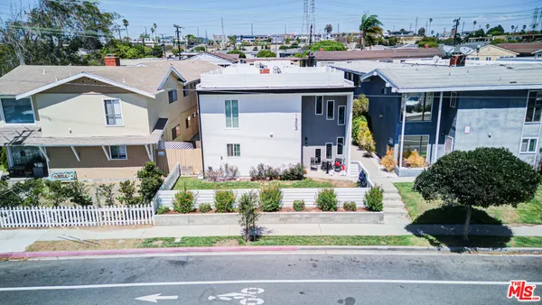 a aerial view of a house with a yard and potted plants