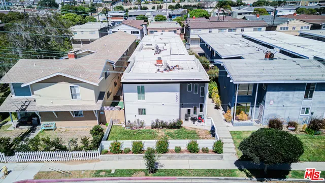 an aerial view of a house with a yard and plants
