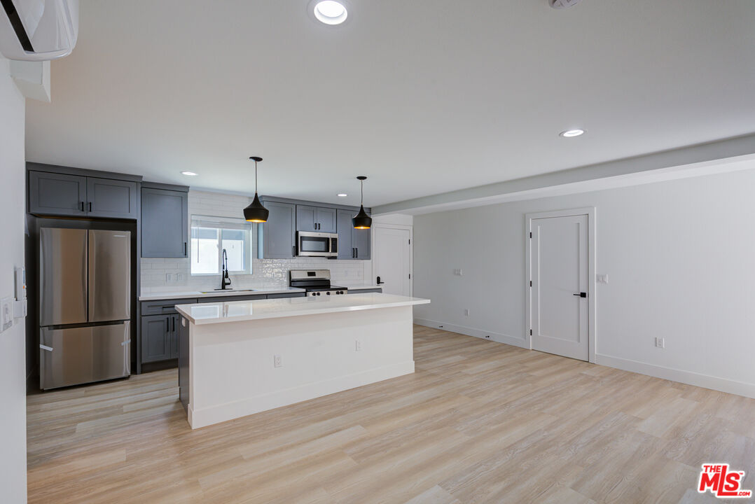 1303 Beryl Street Redondo Beach, CA 90277 - Photo 9 of 31 a kitchen with stainless steel appliances a refrigerator sink and cabinets