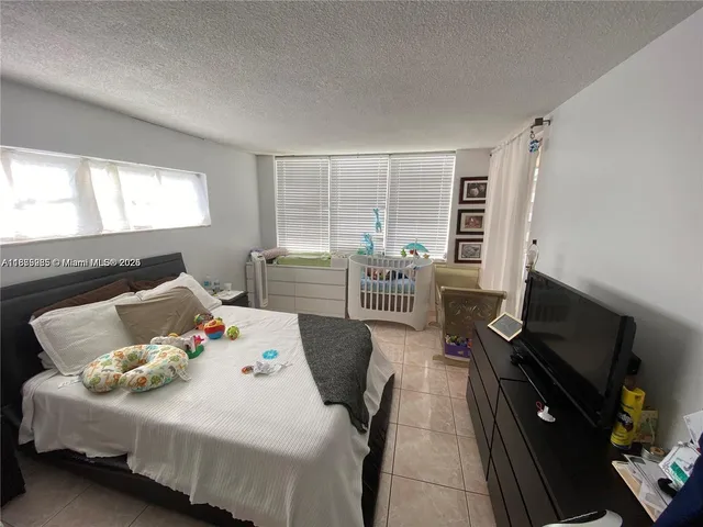 a bed room with a bed and a television