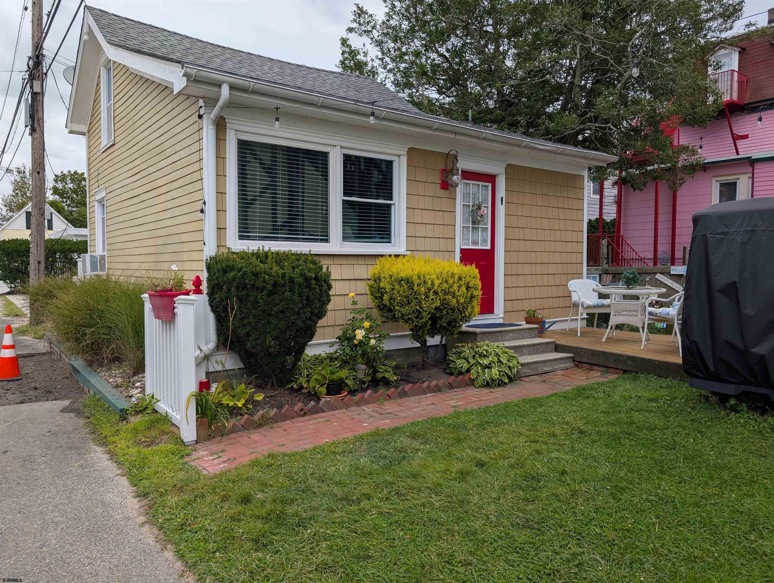 509 East 4th Street, Unit COTTAGE Ocean City, NJ 08226 - Photo 2 of 13 a front view of a house with garden