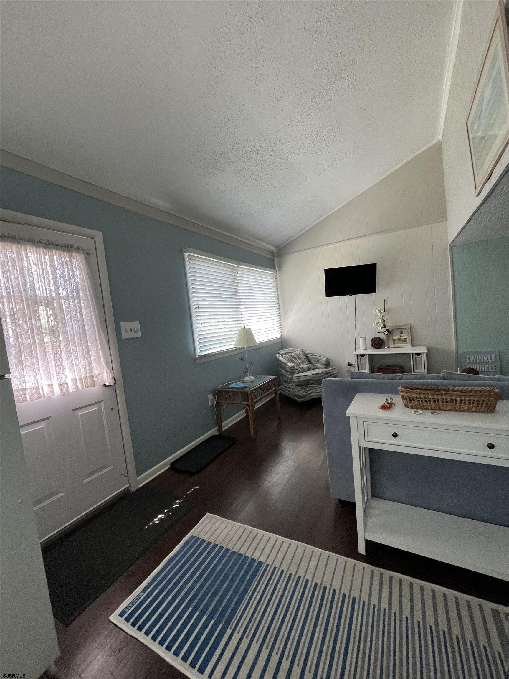 509 East 4th Street, Unit COTTAGE Ocean City, NJ 08226 - Photo 5 of 13 a living room with hard wood floors and a window