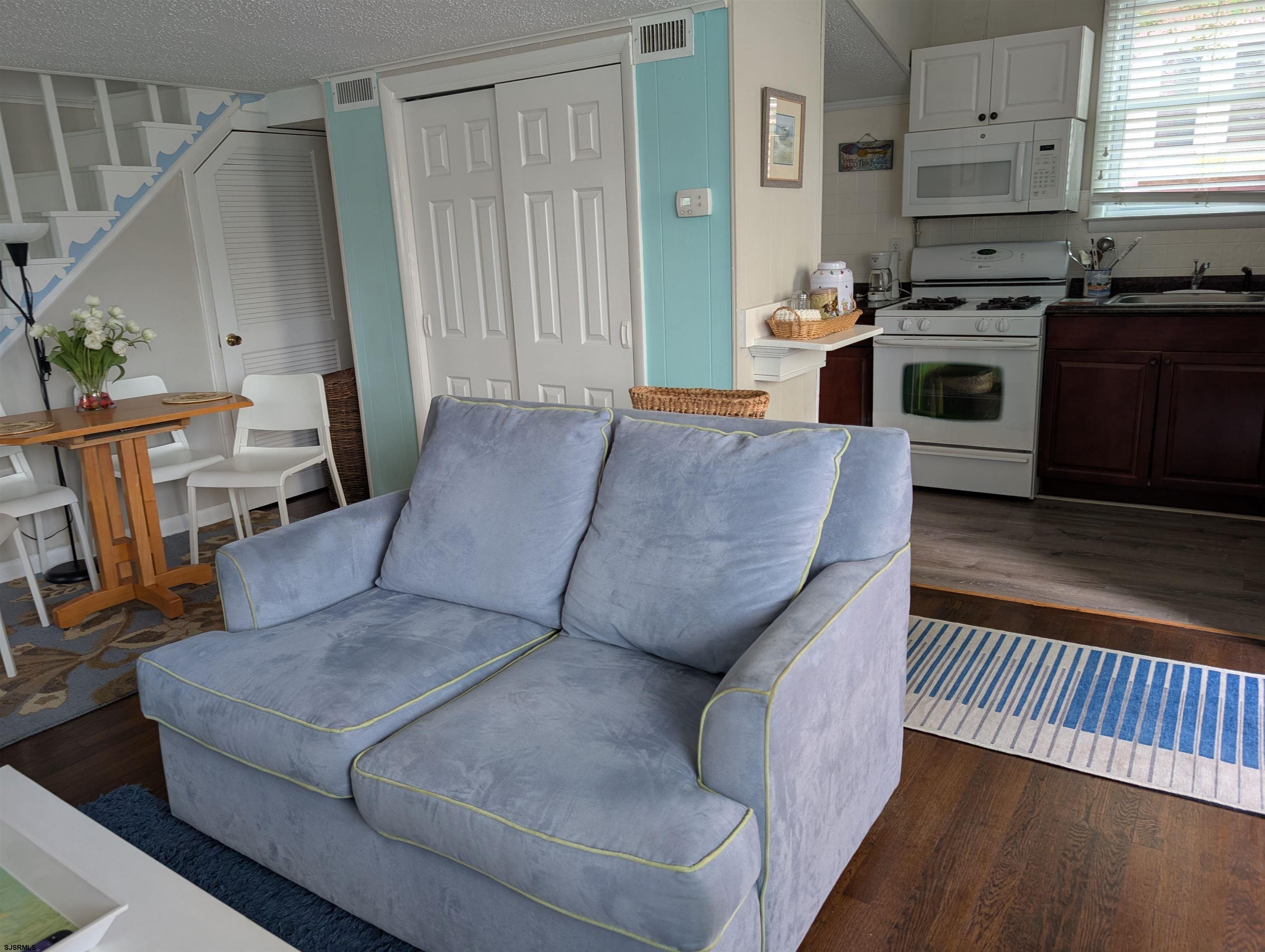 509 East 4th Street, Unit COTTAGE Ocean City, NJ 08226 - Photo 9 of 13 a living room with furniture and a fireplace