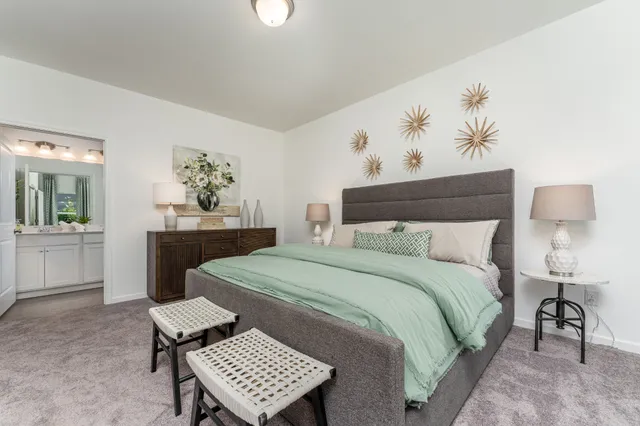 a bedroom with a bed and a table in it with window