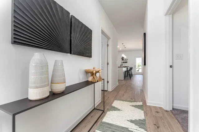 a hallway with a view of living room