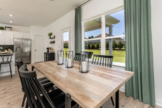 a dining room with furniture and window