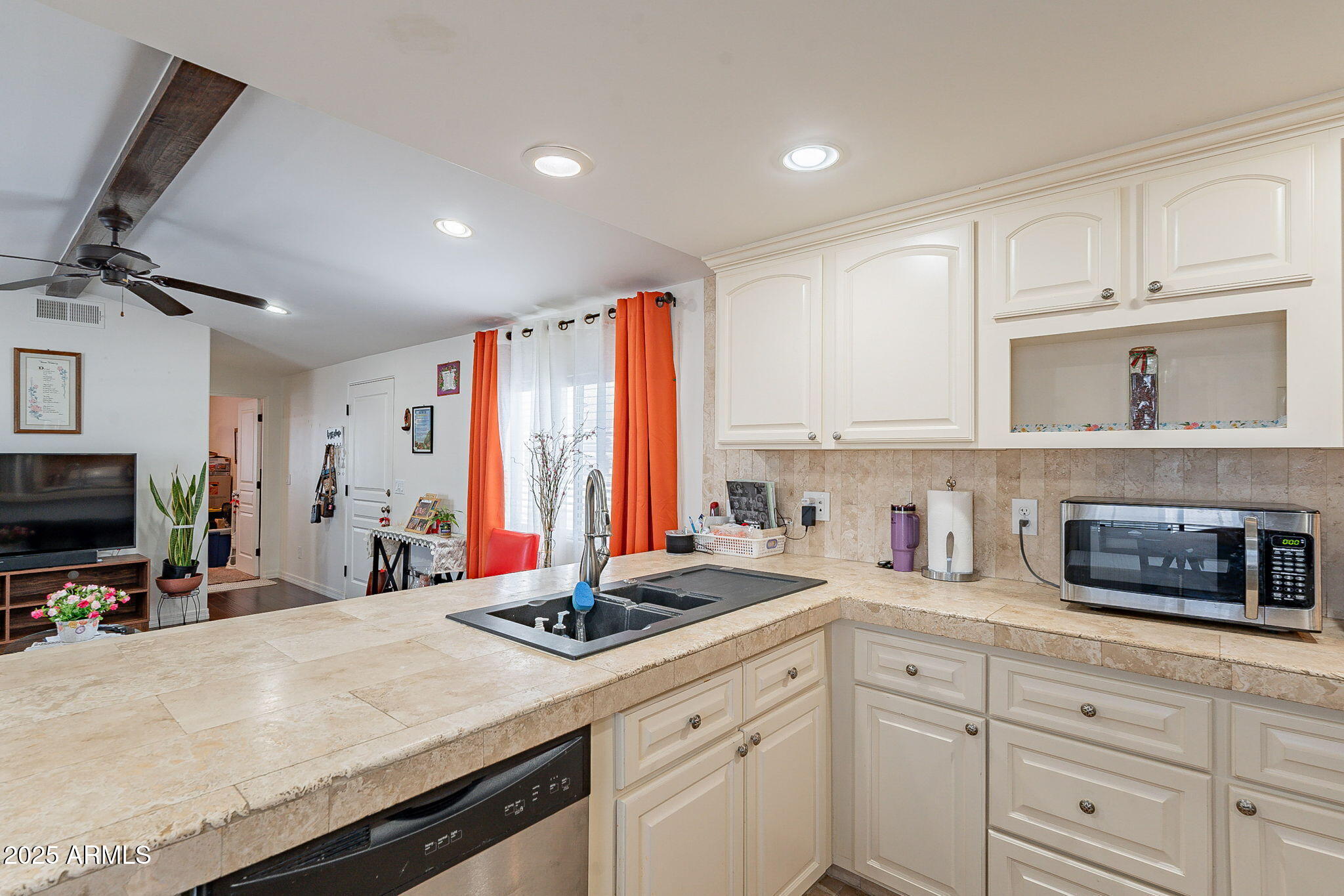 15606 South Gilbert Road, Unit 63 Chandler, AZ 85225 - Photo 9 of 21 a kitchen with stainless steel appliances a stove a sink and a microwave