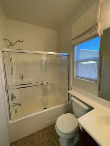 a bathroom with a toilet and a shower