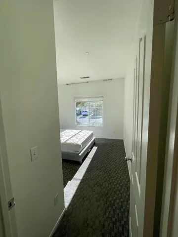 a bathroom with a granite countertop sink and a toilet