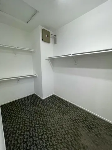 a view of empty room with wooden floor and fireplace