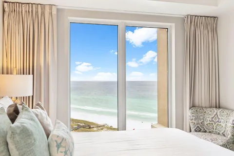 a bed sitting in a bedroom next to a window