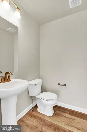 a white toilet sitting next to a bathroom sink