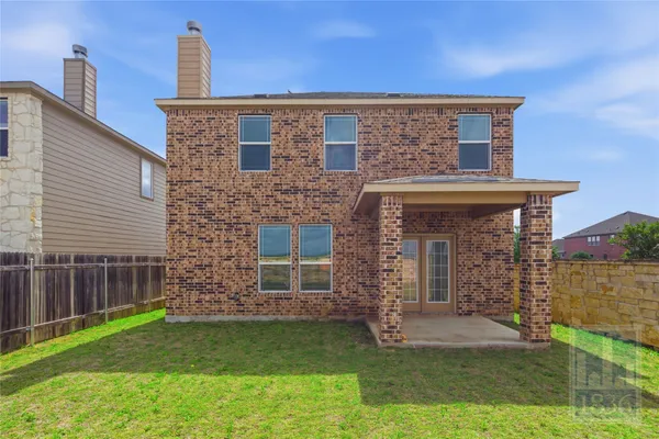 a view of a house with a yard and sitting area