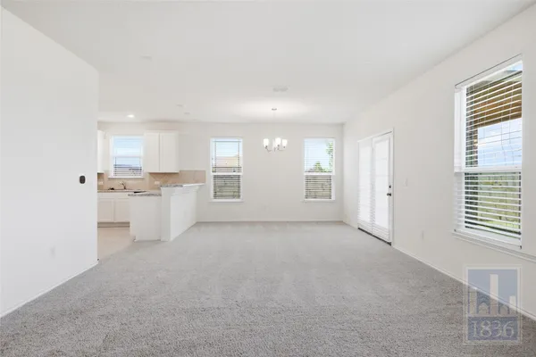 a view of a kitchen with white cabinets and sink