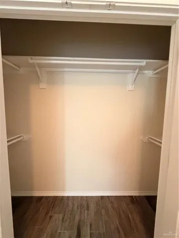 a view of closet with wooden floor