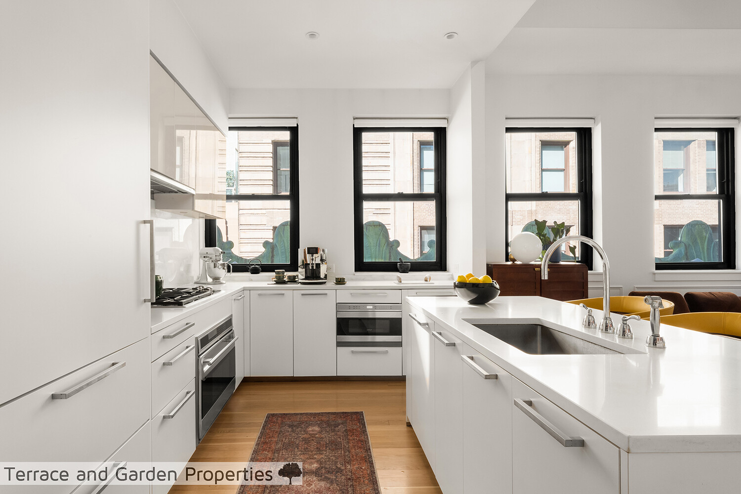 25 Broad Street, Unit PH2D Manhattan, NY 10004 - Photo 8 of 21 a kitchen with a sink and white cabinets